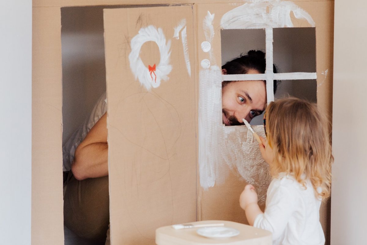 casetta di cartone con bambina e papà